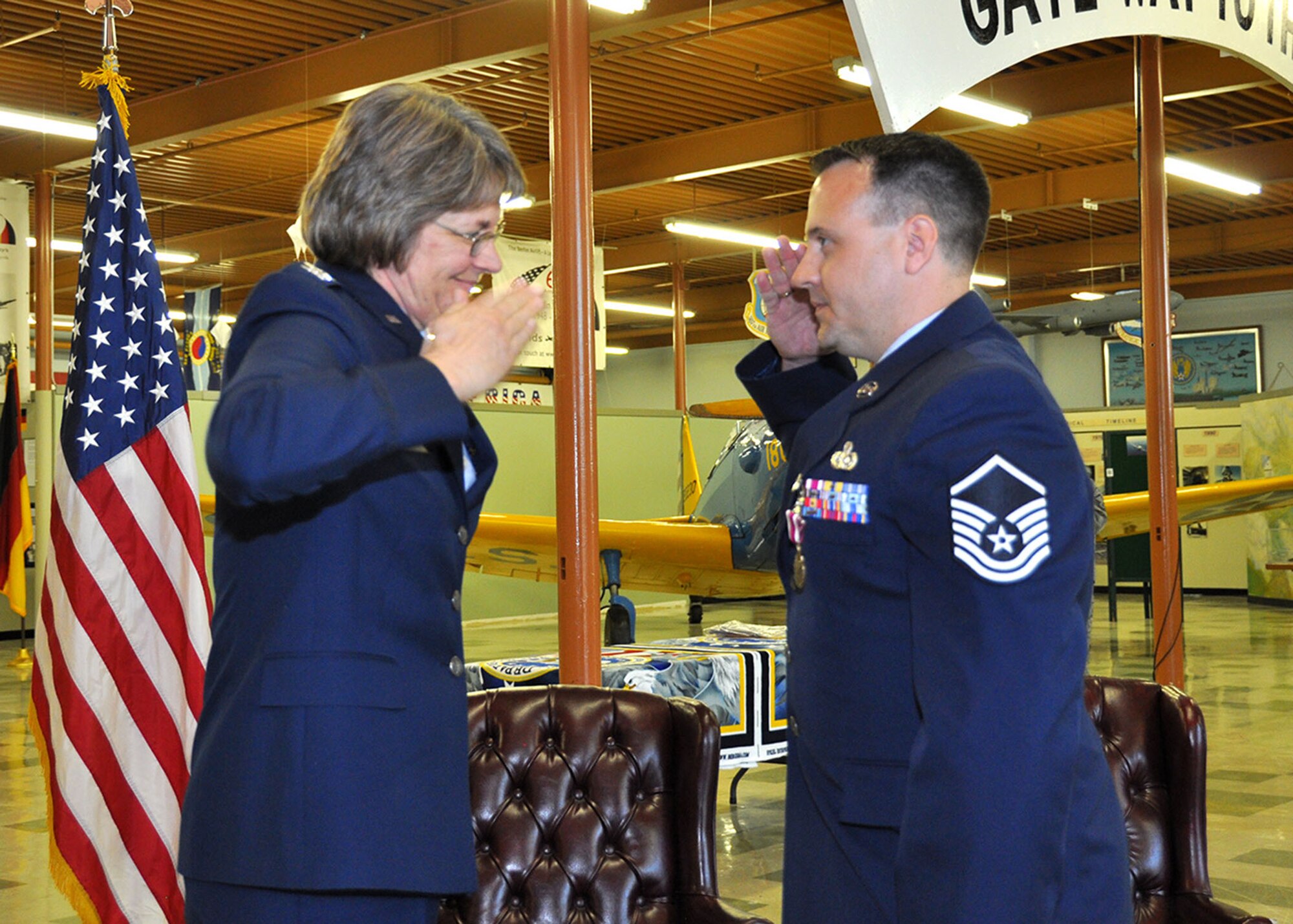TRAVIS AIR FORCE BASE, Calif. --  Col. Nancy Brooks, 349 Mission Support Group commander, salutes Master Sgt. Colin Baldwin at his retirement ceremony held at the Travis Heritage Center, April 20.  (U.S. Air Force photo / Senior Master Sgt. Robert Wade) 
