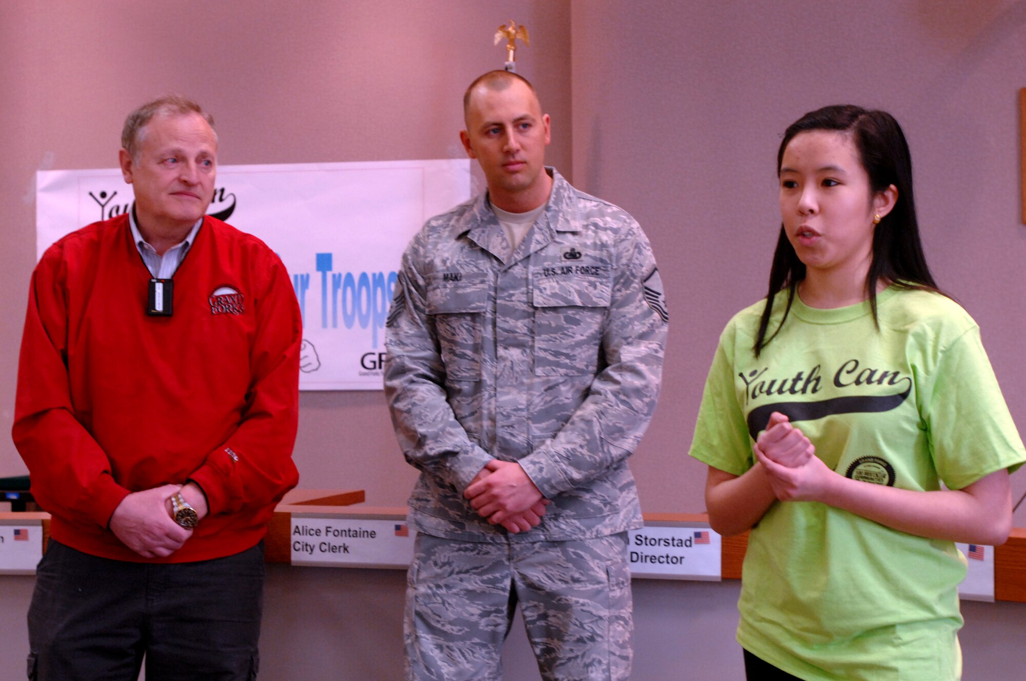 From left, Grand Forks Mayor Michael R. Brown; Master Sgt. Jesse Maki, Grand Forks Air Force Base Airman & Family Readiness Center Superintendent; and Margarita Consing, Grand Forks Youth Commission, offered opening remarks to volunteers who came out to assemble care packages for deployed troops April 27, 2013. About a dozen service members from Grand Forks Air Force Base, N.D., teamed up with the mayor’s office and 35 members of the Grand Forks Youth Commission packed nearly 200 boxes of goods, totaling about $5,500 in value, to be received by about 90 deployed active-duty Airmen and a dozen North Dakota Air National Guardsmen. (U.S. Air Force photo/Staff Sgt. Susan L. Davis)