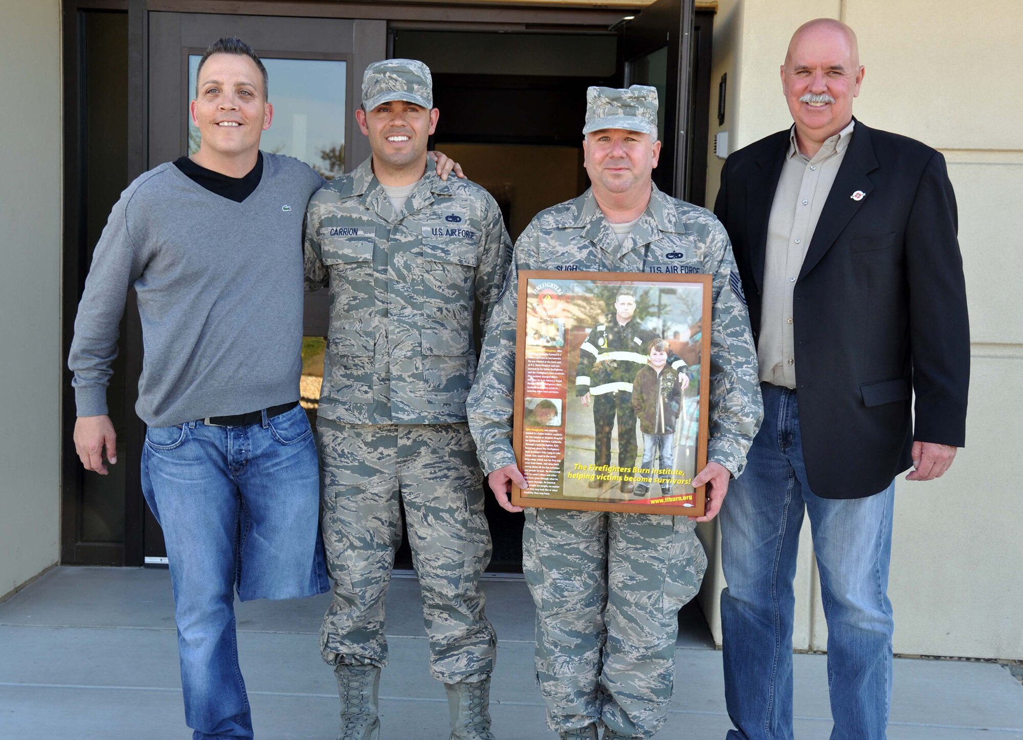 TRAVIS AIR FORCE BASE, Calif. -- Chris Cvitanov, a burn victim survivor, Staff Sgt. Marcus Carrion, 349th Aircraft Maintenance Squadron Rising Six executive director, Tech. Sgt. Michael S. Sligh, 349th AMXS Rising Six president and Jim Doucette, executive director of the Firefighters Burn Institute work together to provide volunteer opportunities for 349th AMXS airmen and others on Travis Air Force Base willing to help the Firefighters Burn Institute. The institute helps burn victims through camps, counseling, and through various other services. Last year, Carrion, along with the help of the 349th AMXS Rising Six, donated 1,500 toys the institute which were distributed to children during the holiday season. (U.S. Air Force photo by Senior Airman Amelia Leonard)