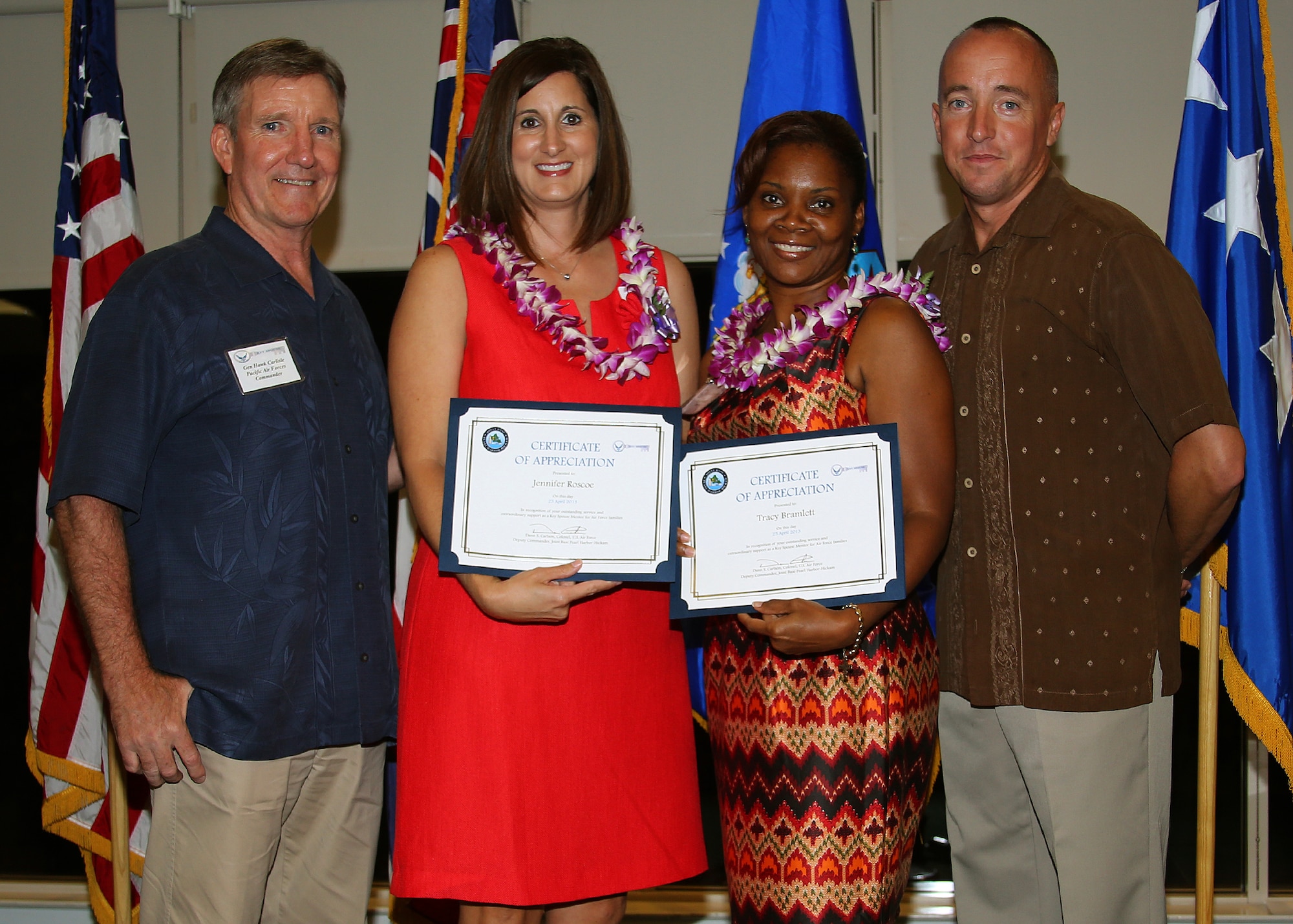 Gen. Herbert J. “Hawk” Carlisle, Pacific Air Forces commander, far left, and Col. Dann S. Carlson, 647th Air Base Group commander, far right, presents certificates to Jennifer Roscoe and Tracey Bramlett during the Hickam Key Spouse Appreciation Ceremony, at the Tradewinds Enlisted Club at Joint Base Pearl Harbor Hickam, Hawaii, April 25, 2013. The spouses received certificates in recognition of their outstanding service and extraordinary support as key spouse mentors for Air Force families. (Courtesy photo)