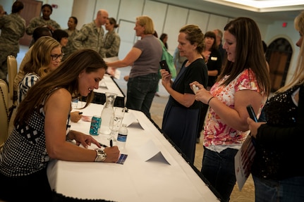 Actress Brooke Shields, from the television show Army Wives, signs an autograph for a military spouse during a meet and greet session April 26, 2013, at the Charleston Club on Joint Base Charleston – Air Base, S.C. Army Wives tells the story of four women and one man who are brought together by their common bond - they all have military spouses. The series is based on the book "Under the Sabers: The Unwritten Code of Army Wives" by Tanya Biank and is produced by ABC Television Studio and The Mark Gordon Company. (U.S. Air Force photo/Senior Airman Dennis Sloan)