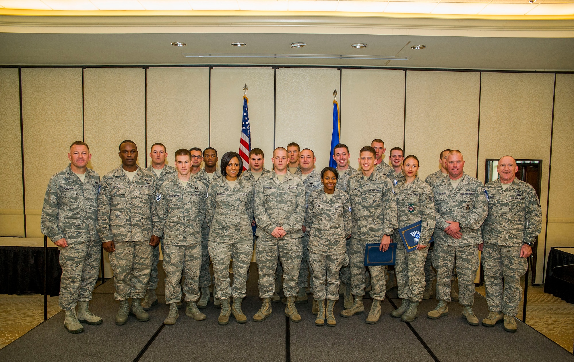 Members of Joint Base Charleston pose for a group photo with Col. Richard McComb, JB Charleston commander, and Chief Master Sgt. Al Hannon, 628th Air Base Wing command chief, after a promotion ceremony April 30, 2013, at JB Charleston. 26 members of JB Charleston were recently promoted. (U.S. Air Force photo/ Senior Airman George Goslin)