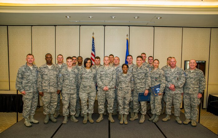 Members of Joint Base Charleston pose for a group photo with Col. Richard McComb, JB Charleston commander, and Chief Master Sgt. Al Hannon, 628th Air Base Wing command chief, after a promotion ceremony April 30, 2013, at JB Charleston. 26 members of JB Charleston were recently promoted. (U.S. Air Force photo/ Senior Airman George Goslin)