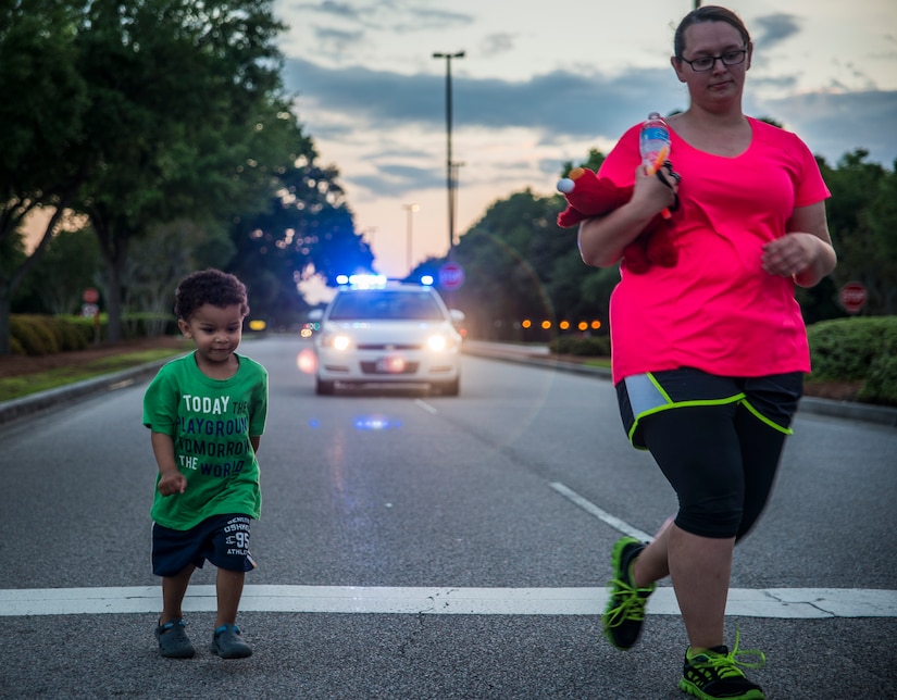 Senior Airman Heather Knockaert, 628th Comptroller Squadron finance specialist, walks with her son Mateo during the “Take Back the Night Walk” to bring awareness to sexual assaults April, 30, 2013, at Joint Base Charleston – Air Base, S.C. The event marked the end of Sexual Assault Awareness Month. (U.S. Air Force photo/ Senior Airman Dennis Sloan)