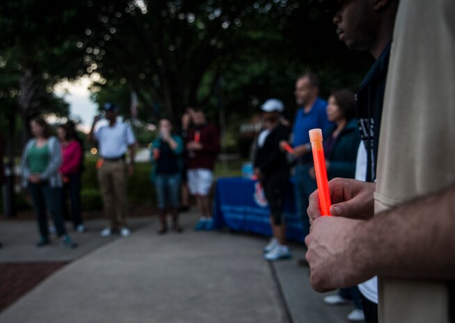 Airmen and their families carried glow sticks as they walked down Hill Blvd. during the “Take Back the Night Walk” to bring awareness to sexual assaults April, 30, 2013, at Joint Base Charleston – Air Base, S.C. The event marked the end of Sexual Assault Awareness Month. (U.S. Air Force photo/ Senior Airman Dennis Sloan)