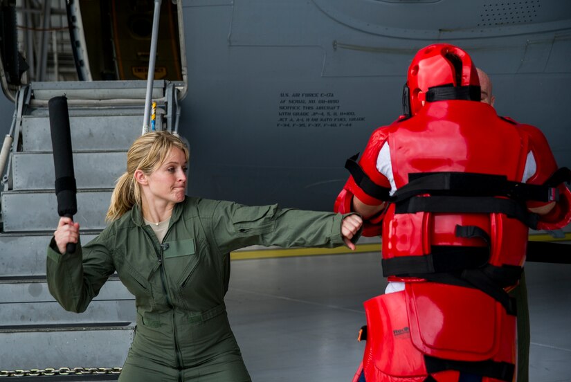 Sara Haines, NBC TODAY Show correspondent, practices using a baton on a mock attacker from the 628th Security Forces Squadron Ravens team during a visit April 19, 2013, at Joint Base Charleston – Air Base, S.C. Haines met with members from the 437th Aircraft Maintenance Squadron, 14th Airlift Squadron, 628th Security Forces Squadron Ravens team and 437th Aerial Port Squadron for a segment for the TODAY show. Each interview included hands-on interaction with Airmen who explained their jobs and their roles in achieving the Air Force mission. (U.S. Air Force photo/ Senior Airman George Goslin)
