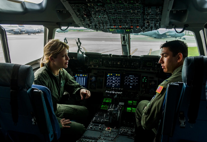 First Lieutenant Leonard Trujillo, 14th Airlift Squadron pilot, explains the various C-17 Globemaster III cockpit systems controls to Sara Haines, NBC TODAY Show correspondent, during a visit April 19, 2013, at Joint Base Charleston – Air Base, S.C. Haines met with members from the 437th Aircraft Maintenance Squadron, 14th Airlift Squadron, 628th Security Forces Squadron Ravens team and 437th Aerial Port Squadron for a segment for the TODAY show. Each interview included hands-on interaction with Airmen who explained their jobs and their roles in achieving the Air Force mission. (U.S. Air Force photo/ Senior Airman George Goslin)