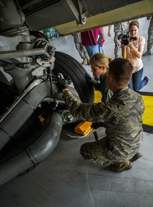 Elizabeth Neumann, an NBC TODAY Show producer, tapes Senior Airman Jay O'Neil, 437th Aircraft Maintenance Squadron crew chief, and Sara Haines, NBC Today Show correspondent, as O’Neil explains the wheel assembly on a C-17 Globemaster III during a visit April 19, 2013, at Joint Base Charleston – Air Base, S.C. Haines met with members from the 437th Aircraft Maintenance Squadron, 14th Airlift Squadron, 628th Security Forces Squadron Ravens team and 437th Aerial Port Squadron for an upcoming segment of the TODAY show. Each interview included hands-on interaction with Airmen who explained their jobs and their roles in achieving the Air Force mission.  (U.S. Air Force photo/ Senior Airman George Goslin)