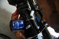Durrell Dawson, an NBC TODAY Show producer, records Senior Airman Jay O'Neil, 437th Aircraft Maintenance Squadron crew chief, and Sara Haines, NBC Today Show correspondent, as O’Neil explains the wheel assembly on a C-17 Globemaster III during a visit April 19, 2013, at Joint Base Charleston – Air Base, S.C. Haines met with members from the 437th Aircraft Maintenance Squadron, 14th Airlift Squadron, 628th Security Forces Squadron Ravens team and 437th Aerial Port Squadron for a segment for the TODAY show. Each interview included hands-on interaction with Airmen who explained their jobs and their roles in achieving the Air Force mission.  (U.S. Air Force photo/ Senior Airman George Goslin)