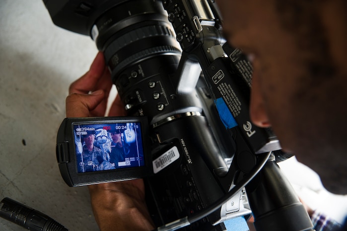 Durrell Dawson, an NBC TODAY Show producer, records Senior Airman Jay O'Neil, 437th Aircraft Maintenance Squadron crew chief, and Sara Haines, NBC Today Show correspondent, as O’Neil explains the wheel assembly on a C-17 Globemaster III during a visit April 19, 2013, at Joint Base Charleston – Air Base, S.C. Haines met with members from the 437th Aircraft Maintenance Squadron, 14th Airlift Squadron, 628th Security Forces Squadron Ravens team and 437th Aerial Port Squadron for a segment for the TODAY show. Each interview included hands-on interaction with Airmen who explained their jobs and their roles in achieving the Air Force mission.  (U.S. Air Force photo/ Senior Airman George Goslin)