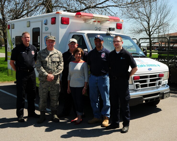 (L to R) David Harding; Firefighter; Rochester Fire Department; Chief Master Sgt. Thomas Buschang; 30th Aerial Port Squadron Superintendant; Lee and Maurine Johnson; Puerto Plata Rochester Sister City Committee; Lt. Willie Jackson; Firefighter, Rochester Fire Department, and Brandon McCCaughey, Emergency Medical Technician, Rural Metro Ambulance pose for a group photo at the Niagara Falls Air Reserve Station on May 1, 2013. The group has assembled outdated  firefighting equipment and an ambulance to be transported by the 914th to Plata Plata, Dominican Republic. Chief Buschang and other members of 30 APS were on hand to unload the equipment, palletize it for flight aboard a C-130 in the coming weeks. (U.S. Air Force photo by Peter Borys)