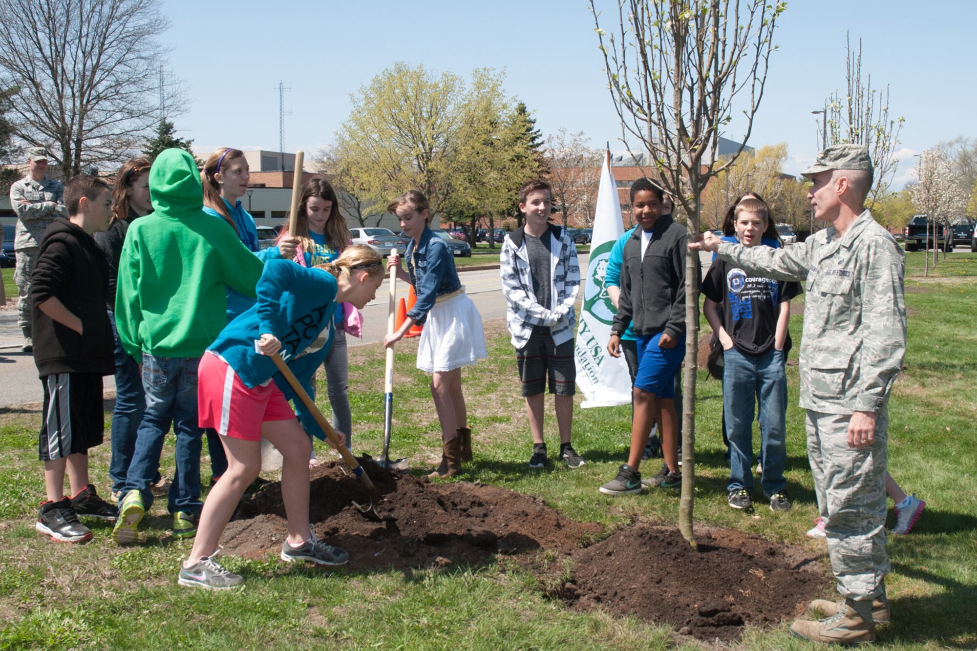 HANSCOM AIR FORCE BASE, Mass. --  Col. Lester A. Weilacher, 66th Air Base Group commander, holds up a tree as students from Hanscom Middle School participate in the tree planting ceremony on the east side of Eglin Street, across from the clinic, April 26. Arbor Day is held on the last Friday in April and is used to celebrate how trees enrich people's lives. Trees at Hanscom help to clean the air, conserve soil, moderate temperature and bring nature into a person's daily life. (U.S. Air Force photo by Mark Herlihy)