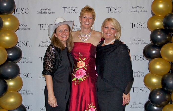 (Left) Bobbi Nitz, spouse of Col. Trevor Nitz, 437th Operations Group commander, Col. Judith Hughes, 628th Medical Group commander and Phyllis McComb, spouse of Col. Richard McComb, Joint Base Charleston commander, experience the glitz and glamour of “Hollywood Nights” during the 2013 Silver Wings Scholarship Auction. The Silent Auction is organized by the Team Charleston Spouses Club, with proceeds of the event being applied toward educational scholarships for military spouses and dependents. (Courtesy photo)