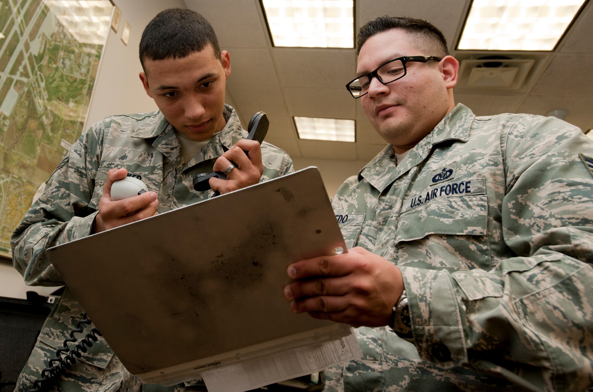 Senior Airman Tony Heilker, 22nd Air Refueling Wing Command Post emergency actions controller, and Staff Sgt. Ricky Loredo, 22nd ARW/CP status of resources and training system NCO in charge, contact with the crew of a KC-135 Stratotanker over the radio April 30, 2013, McConnell Air Force Base, Kan. Heilker and Loredo help keep track of the status of each aerial refueling. (U.S. Air Force photo/Airman 1st Class Victor J. Caputo)