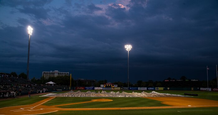 Members of the Charleston RiverDogs staff pull away the infield tarp during the Charleston RiverDogs Military Appreciation Night game April 25, 2013, at the Joseph P. Riley, Jr. Park in Charleston, S.C. The Charleston RiverDogs hosted Military Appreciation night to show their support for the local military. (U.S. Air Force photo/ Senior Airman George Goslin)