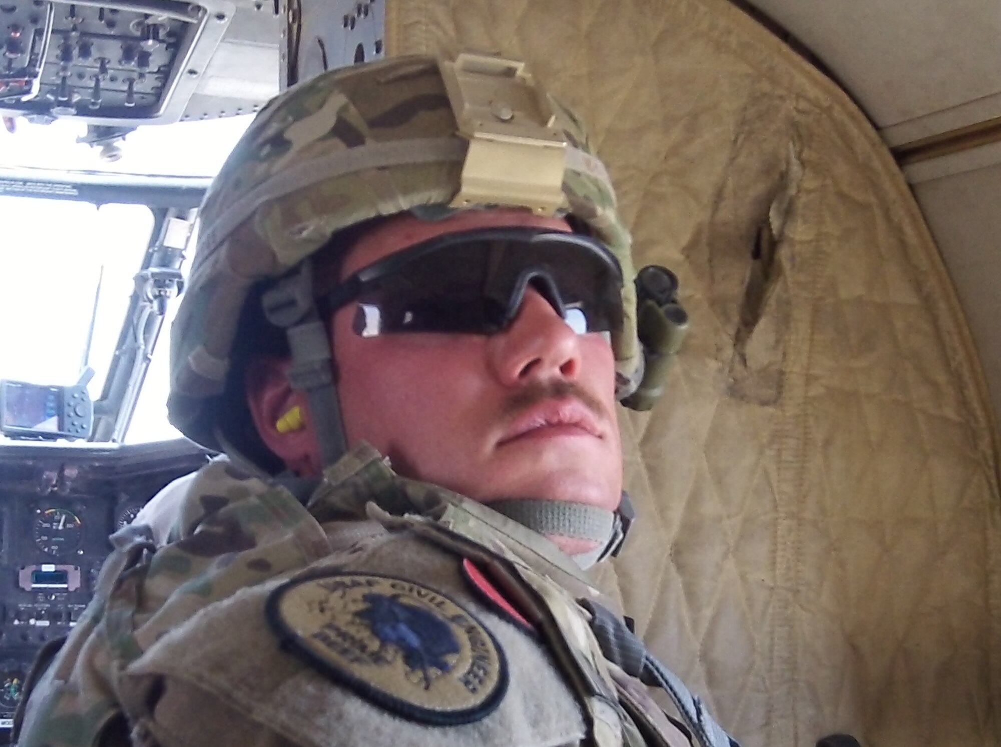 Tech. Sgt. Jason McCarty, 509th Civil Engineer Squadron structural craftsman, rides in a helicopter while deployed to Afghanistan. McCarty spent 14 years as an Air Force firefighter, deploying four times; this is his first deployment since cross-training into the civil engineer structures field. (Courtesy Photo)