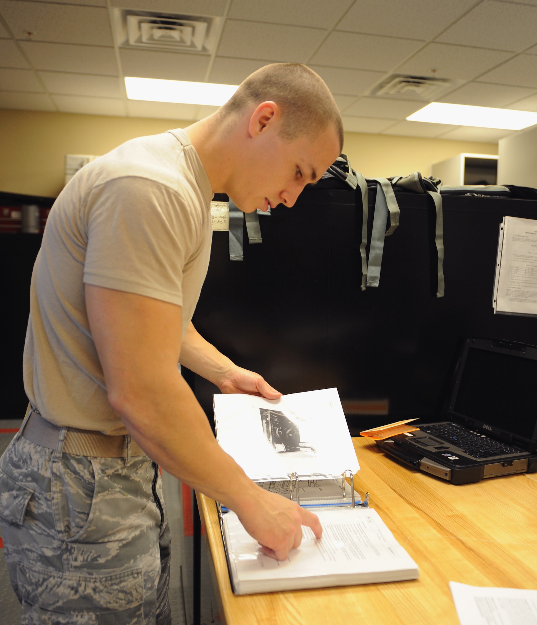 Senior Airman Blake Hill, 2nd Operations Support Squadron Aircrew Flight Equipment, reads a technical order before inflating an OTS-600 anti-exposure suit on Barksdale Air Force Base, La., May 1, 2013. A TO is used to make sure steps are not missed when working on or repairing an item. (U.S. Air Force photo/Airman 1st Class Benjamin Gonsier)  