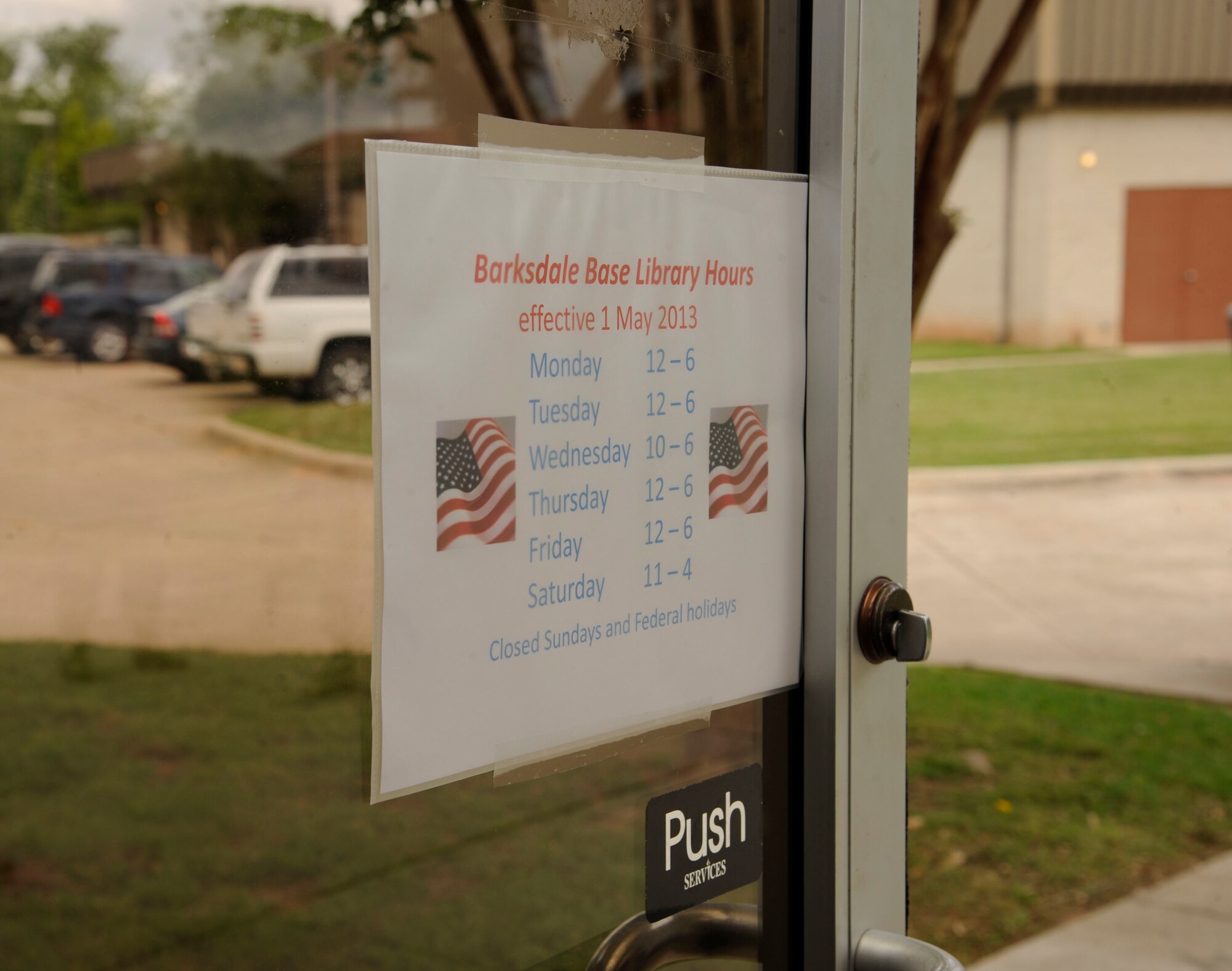 The Barksdale Library's new hours hang on the entrance door on Barksdale Air Force Base, La., May 1, 2013. The library's hours recently changed due to the effects of sequestration. The new hours are 12 p.m. to 6 p.m. Monday, Tuesday, Thursday and Friday, 10 a.m. to 6 p.m. on Wednesdays, and 11 a.m. to 4 p.m. on Saturdays. Though hours are shorter, the library will continue to offer full services during the times they are open. (U.S. Air Force photo/Airman 1st Class Andrew Moua)