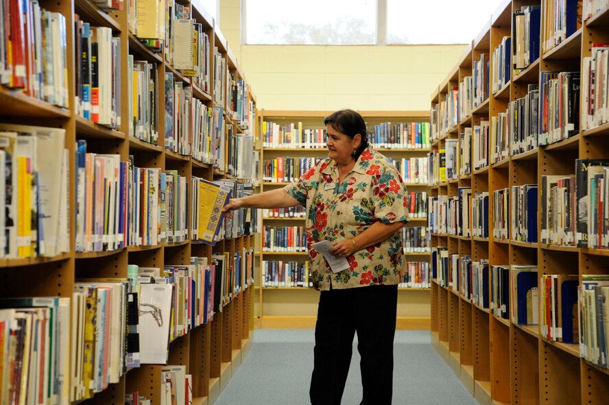 Fran Morris, Barksdale Library Director, organizes a book shelf on Barksdale Air Force Base, La., May 1, 2013. The library's hours recently changed due to the effects of sequestration. The new hours are 12 p.m. to 6 p.m. Monday, Tuesday, Thursday and Friday, 10 a.m. to 6 p.m. on Wednesdays, and 11 a.m. to 4 p.m. on Saturdays. Though hours are shorter, the library will continue to offer full services during the times they are open. (U.S. Air Force photo/Airman 1st Class Andrew Moua)
