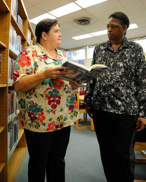 Fran Morris, Barksdale Library Director, assists a patron on Barksdale Air Force Base, La., May 1, 2013. The library's hours recently changed due to the effects of sequestration. The new hours are 12 p.m. to 6 p.m. Monday, Tuesday, Thursday and Friday, 10 a.m. to 6 p.m. on Wednesdays, and 11 a.m. to 4 p.m. on Saturdays. Though hours are shorter, the library will continue to offer full services during the times they are open. (U.S. Air Force photo/Airman 1st Class Andrew Moua)