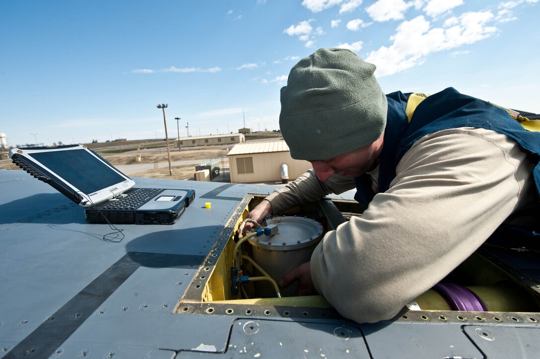 Staff Sgt. Thomas Gillan, 28th Aircraft Maintenance Squadron electrical and environmental lead technician, inspects electrical systems on top of a B-1 bomber at Ellsworth Air Force Base, S.D., April 4, 2013. Aircraft electrical and environmental systems specialists are one of six specialties in the 28th AMXS specialist section responsible for making sure the many systems of the B-1s at Ellsworth function properly. (U.S. Air Force photo by Airman 1st Class Zachary Hada/Released)