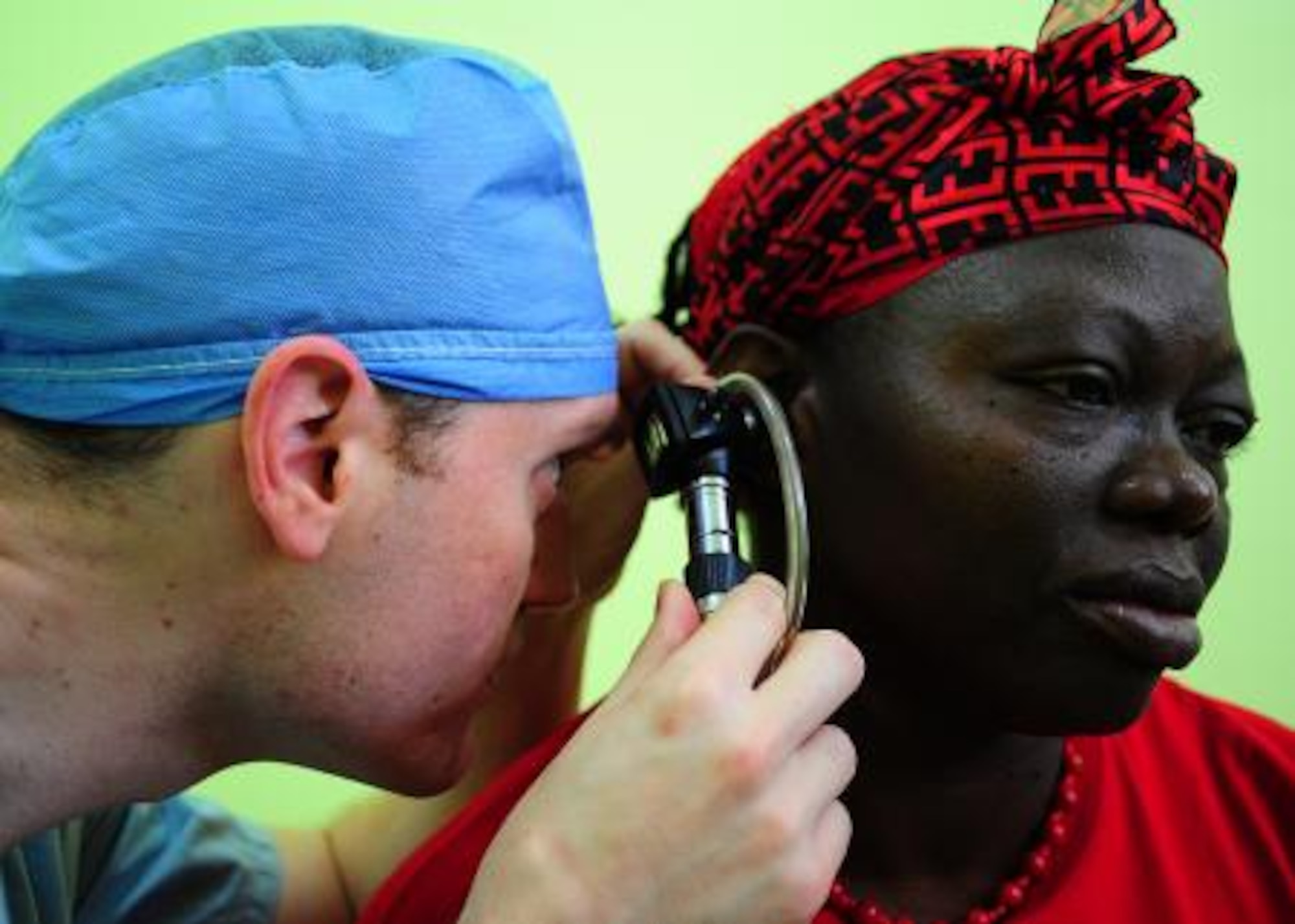 U.S. Army Capt. Jamie Andrews, resident physician from Brooke Army Medical Center at Fort Sam Houston, San Antonio, uses a microscope to check the eardrum of Gwen Nunez Gonzalez during a surgery medical readiness training exercise at Western Regional Hospital in Belmopan, Belize, April 23, 2013. Medical professionals from the U.S. are providing free medical treatment at multiple medical readiness training exercises throughout Belize as part of an exercise known as New Horizons. The MEDRETES are designed to provide humanitarian assistance and medical care to people in several communities, while helping improve the skills of U.S. military medical forces. (U.S. Air Force photo by Tech Sgt. Tony Tolley/Released)