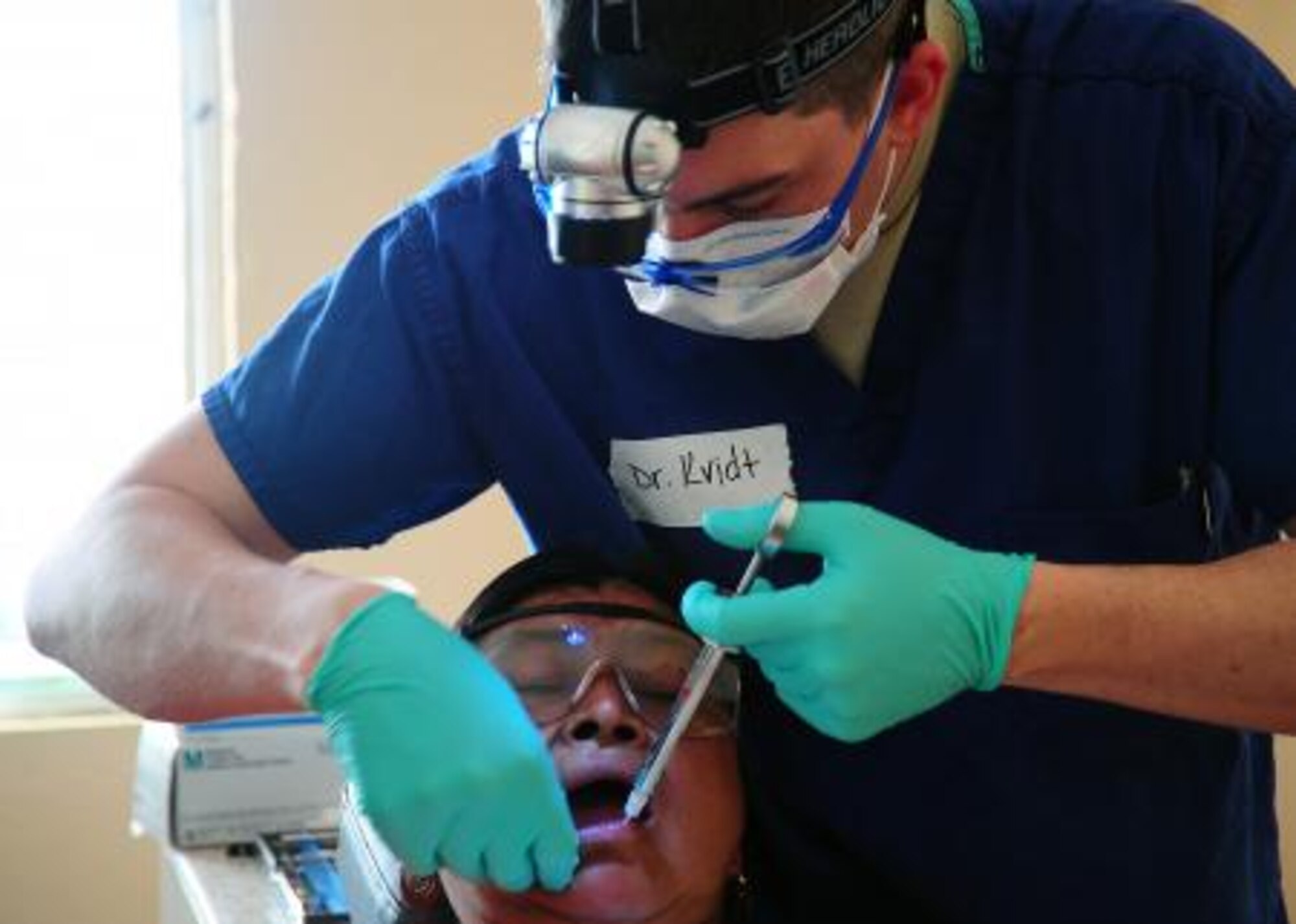U.S. Air Force Capt. Brandon Kvidt, dental resident from Offutt Air Force Base, Neb., administers anesthesia to a Belizean woman during a dental readiness training exercise at the Punta Gorda Hospital annex in Punta Gorda, Belize, April 26, 2013. Dental professionals from the U.S. and Canada are providing free dental treatment at multiple readiness training exercises throughout Belize as part of an exercise known as New Horizons. The training exercises are designed to provide dental care to people throughout Belize, while helping improve the skills of U.S. and Canadian military medical forces. (U.S. Air Force photo by Tech Sgt. Tony Tolley/Released)
