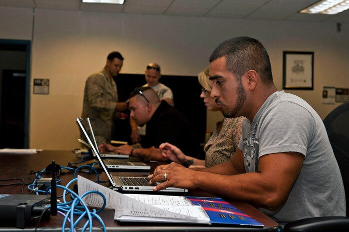 U.S. Marine Corps Sgt. Josue Cervantes, Individual Ready Reserve, updates his current address and information into the Marine Online database April 27, 2013, at Nellis Air Force Base, Nev. Marines that attend the event get briefed by 15 civilian agencies, with the purpose of advising service members of the benefits to which they have access. (U.S. Air Force photo by Daniel Hughes)