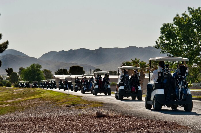 Active-duty, retired, and civilian golfers drive out to their starting holes to participate in the Air Force Assistance Fund Golf Tournament April 26, 2013, at the Sunrise Vista Golf Course at Nellis Air Force Base, Nev. More than 120 golfers took part in the golf tournament, donating proceeds to support the AFAF. (U.S. Air Force photo by Senior Airman Daniel Hughes)