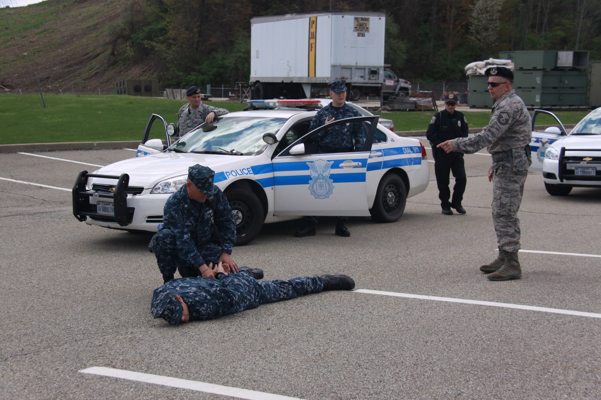 Master Sgt. Frank Powell, 911th Security Forces Squadron standards and evaluations instructor, advises Naval Operational Support Center – Pittsburgh Master-at-Arms personnel on tactics to employ when faced with having to subdue a perpetrator who refuses to cooperate during a routine traffic stop. The mock scenario was created as part of joint traffic stop training between Air Force and Navy reservists at the Pittsburgh International Airport Air Reserve Station, April 30, 2013.  NOSC-Pittsburgh Sailors are ramping up activity on the base as construction of their new headquarters building continues at the 911th. Construction of the new facility is slated to be completed by Spring of 2014. (U.S. Air Force photo by Tech. Sgt. Jamie Perry/Released)