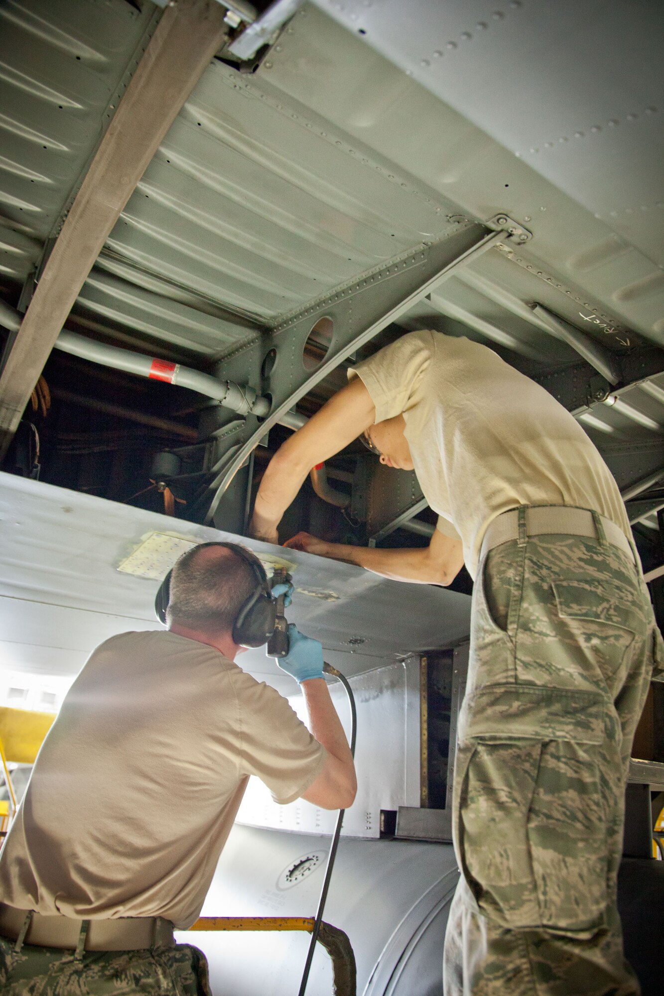 Senior Master Sgt. Aaron Mikonowicz and Staff Sgt. Brent Voss, 934th Maintenance Squadron, repair a lower surface wing crack on a C-130 during an isochronal inspection at the Minneapolis-St. Paul Air Reserve Station, Minn.  (U.S. Air Force photo/Shannon McKay)