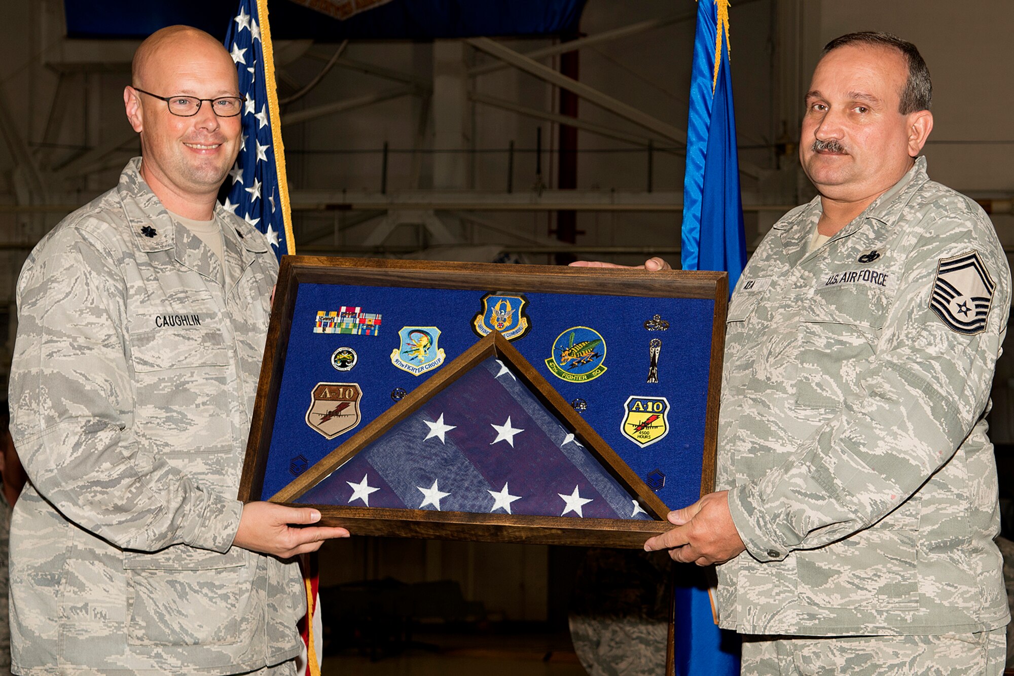 U.S. Air Force Lt. Col. Travis Caughlin, 917th Fighter Group deputy commander of maintenance, presents a career shadow box to Senior Master Sgt. Bobby Kea during a retirement ceremony, April 28, 2013, Barksdale Air Force Base, La. Kea is retiring from the Air Force Reserve after 36 years of service. (U.S. Air Force photo by Master Sgt. Greg Steele/Released)