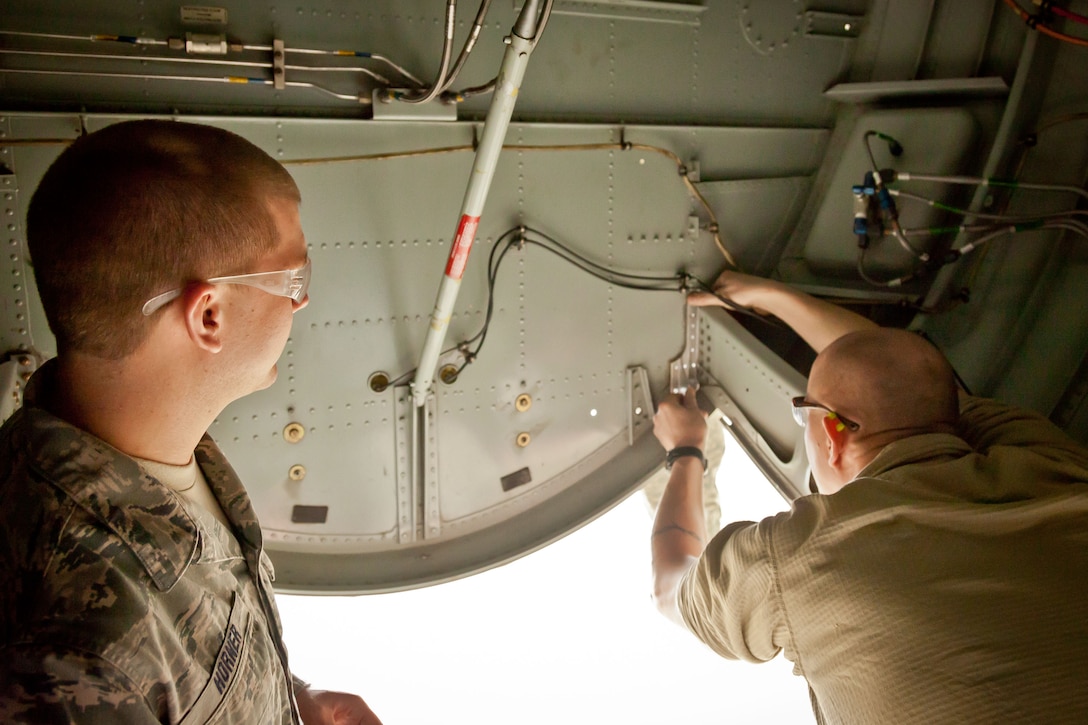 Master Sgt. Eric Johnson and Staff Sgt. Tyler Horner, 934th Maintenance Squadron, fit a part that needs replacing in the nose of a C-130 during an isochronal inspection at the Minneapolis-St. Paul Air Reserve Station, Minn.  (U.S. Air Force photo/Shannon McKay)