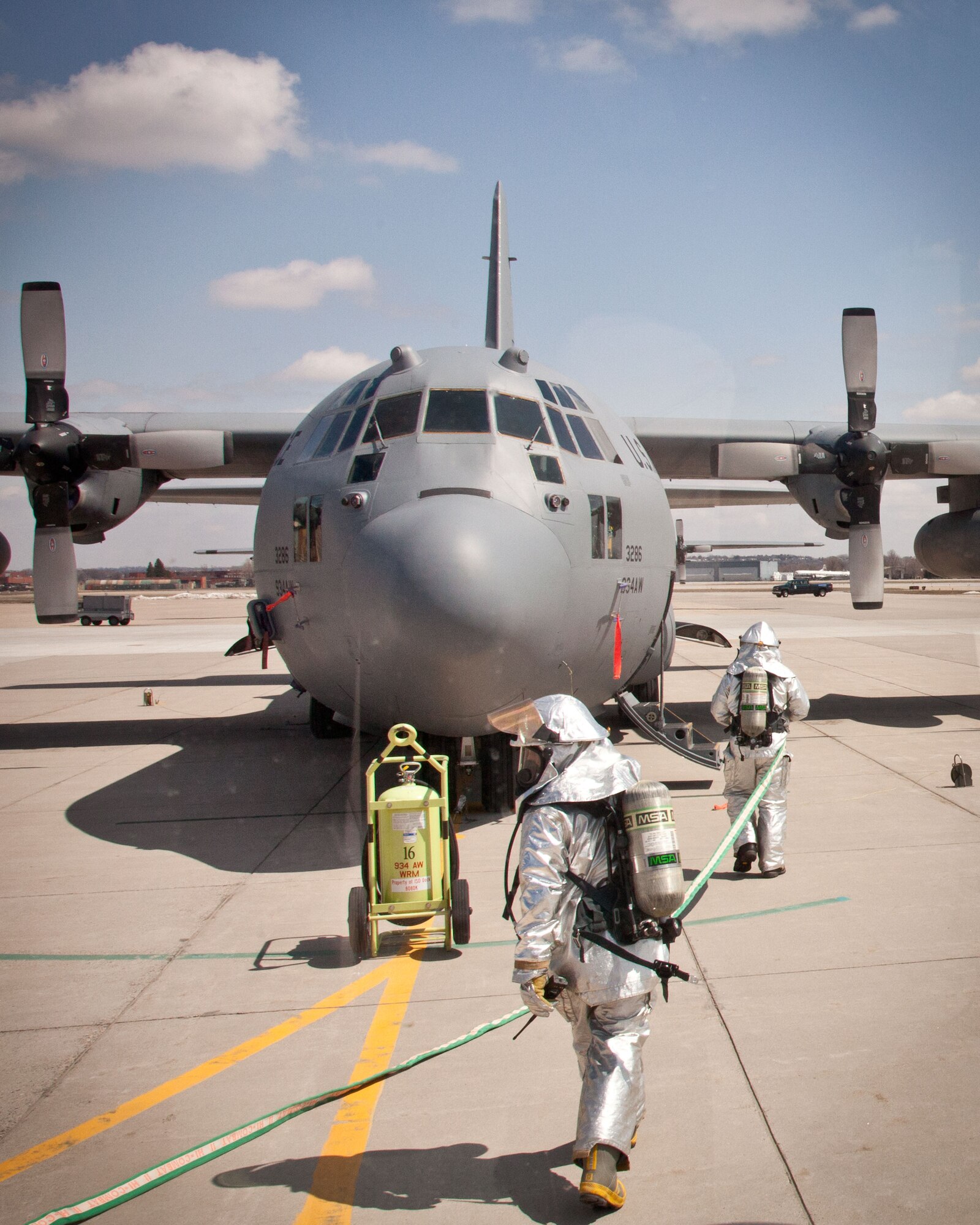 Firefighters from the 934th Civil Engineer Squadron test their skills responding to a simulated C-130 fire during an aircraft emergency exercise at the Minneapolis-St. Paul Air Reserve Station, Minn.  (U.S. Air Force photo/Shannon McKay)