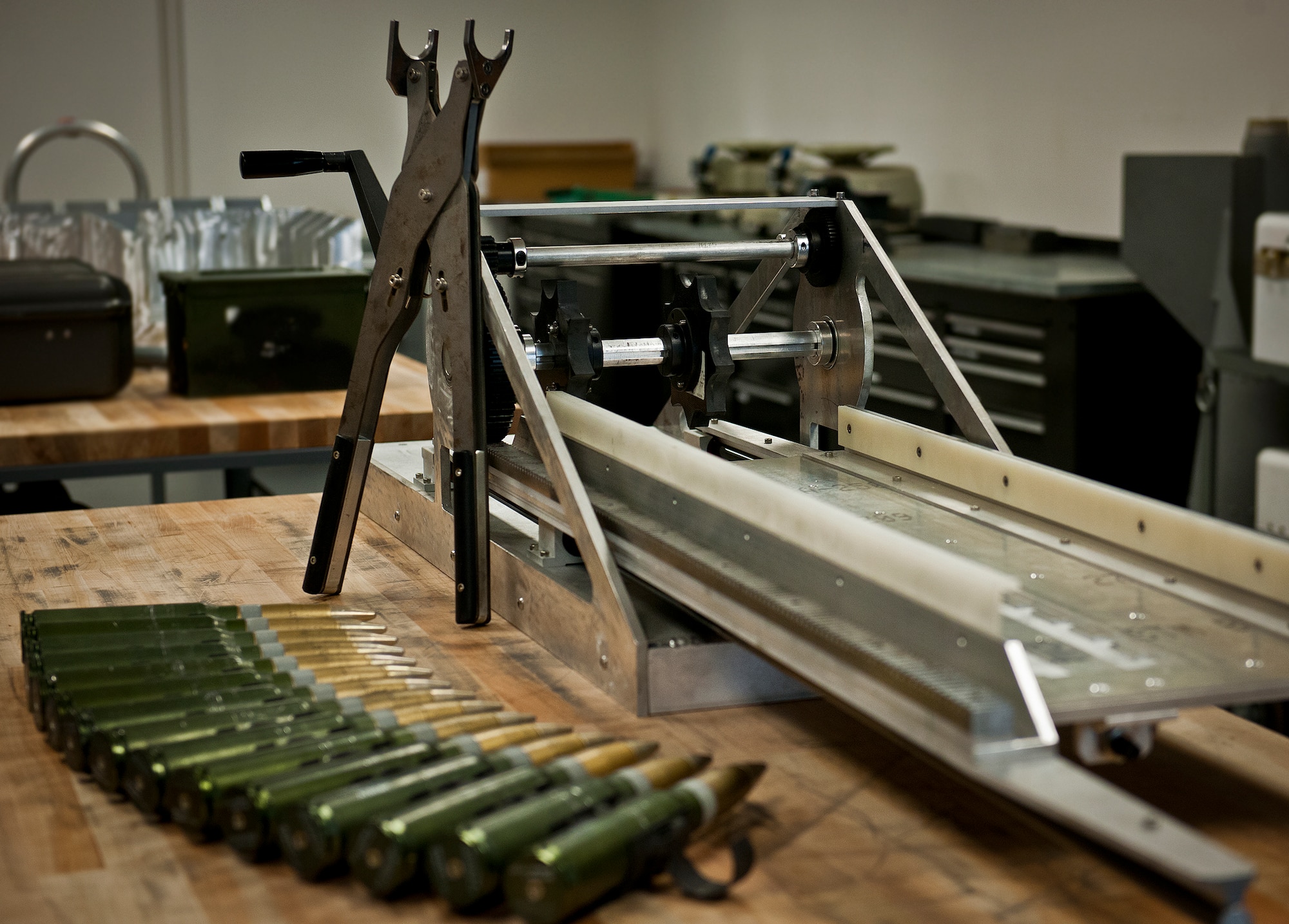 The lightweight, mobile 30mm ammunition round linker and de-linker sit ready for delivery to Air Force Special Operations Command. The linker connects rounds to MK-15 links using a hand crank or a conventional electric drill.  The de-linker (similar to a large set of plyers) disconnects the rounds safely and easily from the MK-15 links. Both products were created by the Munitions Materiel Handling Equipment Focal Point, a section under the Air Force Life Cycle Management Center’s Armament Directorate, specializing in developing locally manufactured equipment for the Air Force ammo and weapons communities.  The new linker is one-tenth the weight and cost of the current ammo linker in use and will be delivered in May.  (U.S. Air Force photo/Samuel King Jr.)