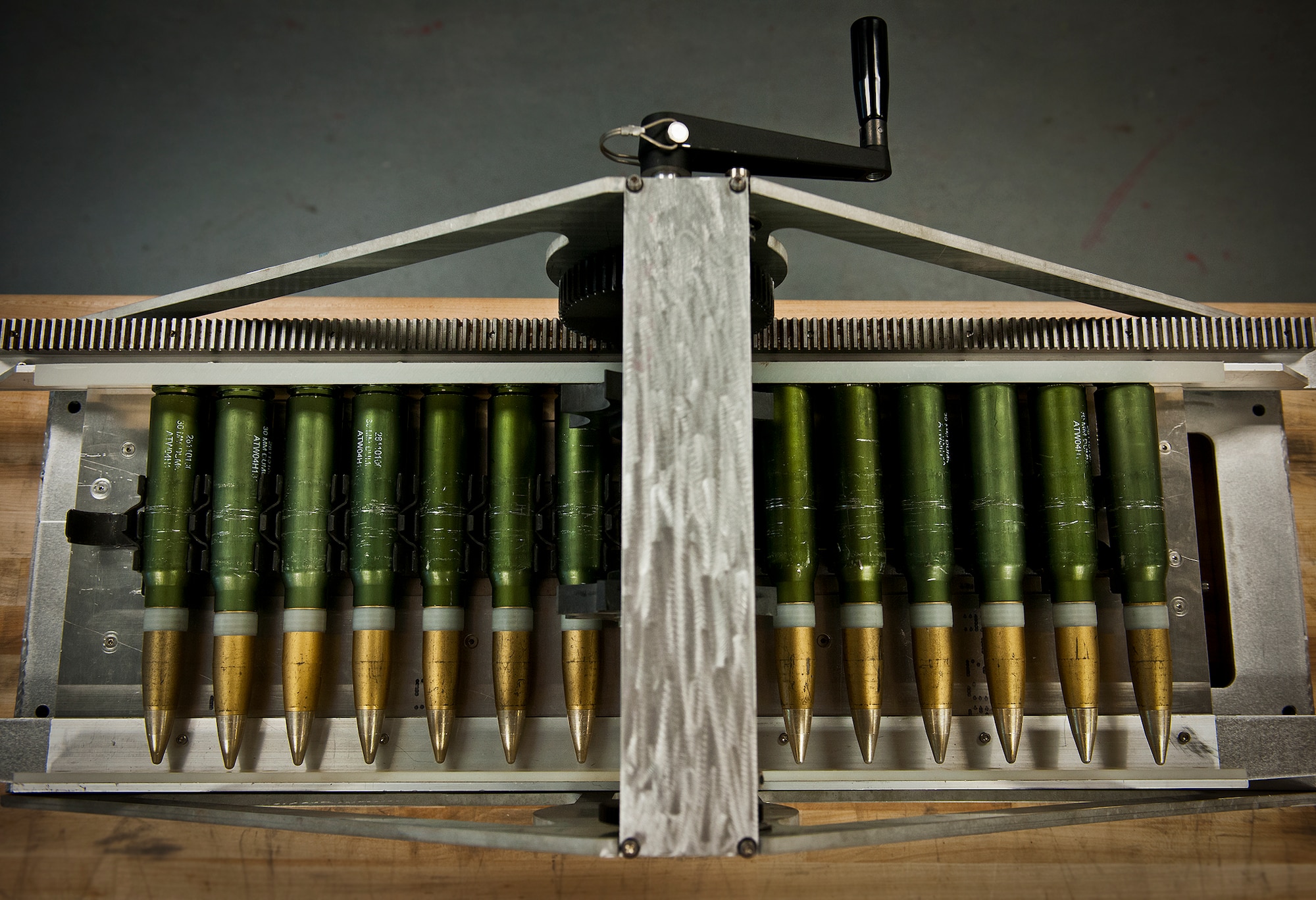 A lightweight, mobile 30mm ammunition round linker connects rounds to MK-15 links using a hand crank or a conventional electric drill.  The linker was created by the Munitions Materiel Handling Equipment Focal Point, a section under the Air Force Life Cycle Management Center’s Armament Directorate, specializing in developing locally manufactured equipment for the Air Force ammo and weapons communities.  The new linker is one-tenth the weight and cost of the current ammo linker in use and will be delivered to Air Force Special Operations Command units in May.  (U.S. Air Force photo/Samuel King Jr.)