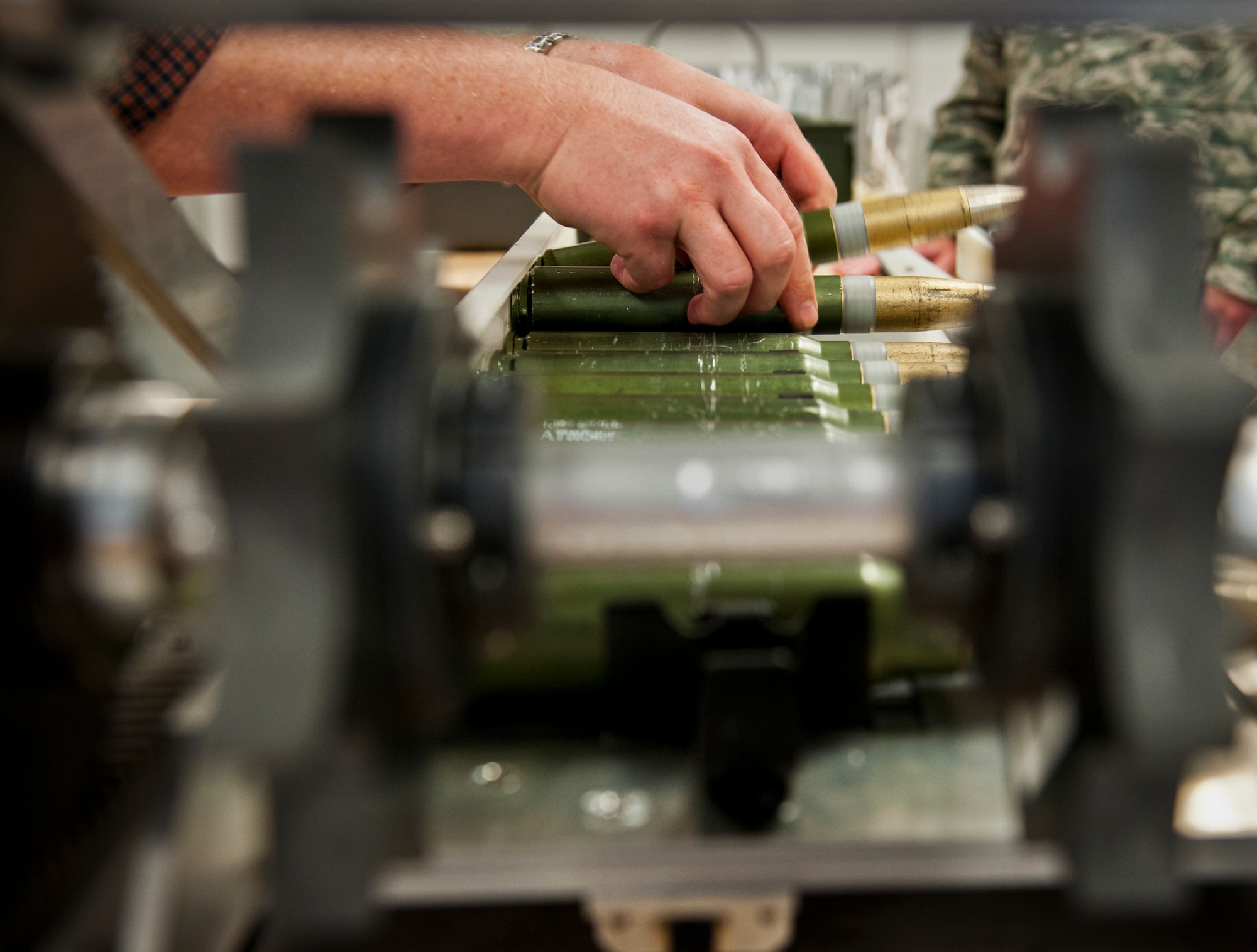 30mm ammunition rounds are loaded into the mobile, hand-cranked linker to be connected with MK-15 links for use on Air Force Special Operations Command C-130 aircraft.  The linker was created by the Munitions Materiel Handling Equipment Focal Point, a section under the Air Force Life Cycle Management Center’s Armament Directorate, specializing in developing locally manufactured equipment for the Air Force ammo and weapons communities.  The new linker is one-tenth the weight and cost of the current ammo linker in use and will be delivered to AFSOC units in May.  (U.S. Air Force photo/Samuel King Jr.)