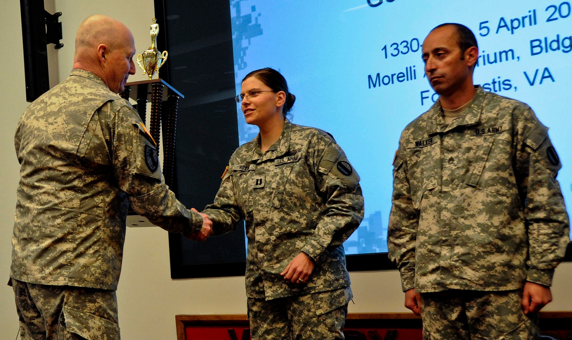 U.S. Army Gen. Bob Cone, commanding general of the U.S. Army Training and Doctrine Command, presents the Brig. Gen. David H. Stem Memorial Award to Capt. Samantha Hoxha, 221st Military Police Detachment commander, and Sgt. 1st Class Douglas Walker, 3rd MPD military working dogs detachment sergeant, during a ceremony at TRADOC Headquarters at Fort Eustis, Va., April 5, 2013. The award honors the command's most outstanding military police unit each year. (U.S. Army photo by Staff Sgt. Steven Schneider/Released)
