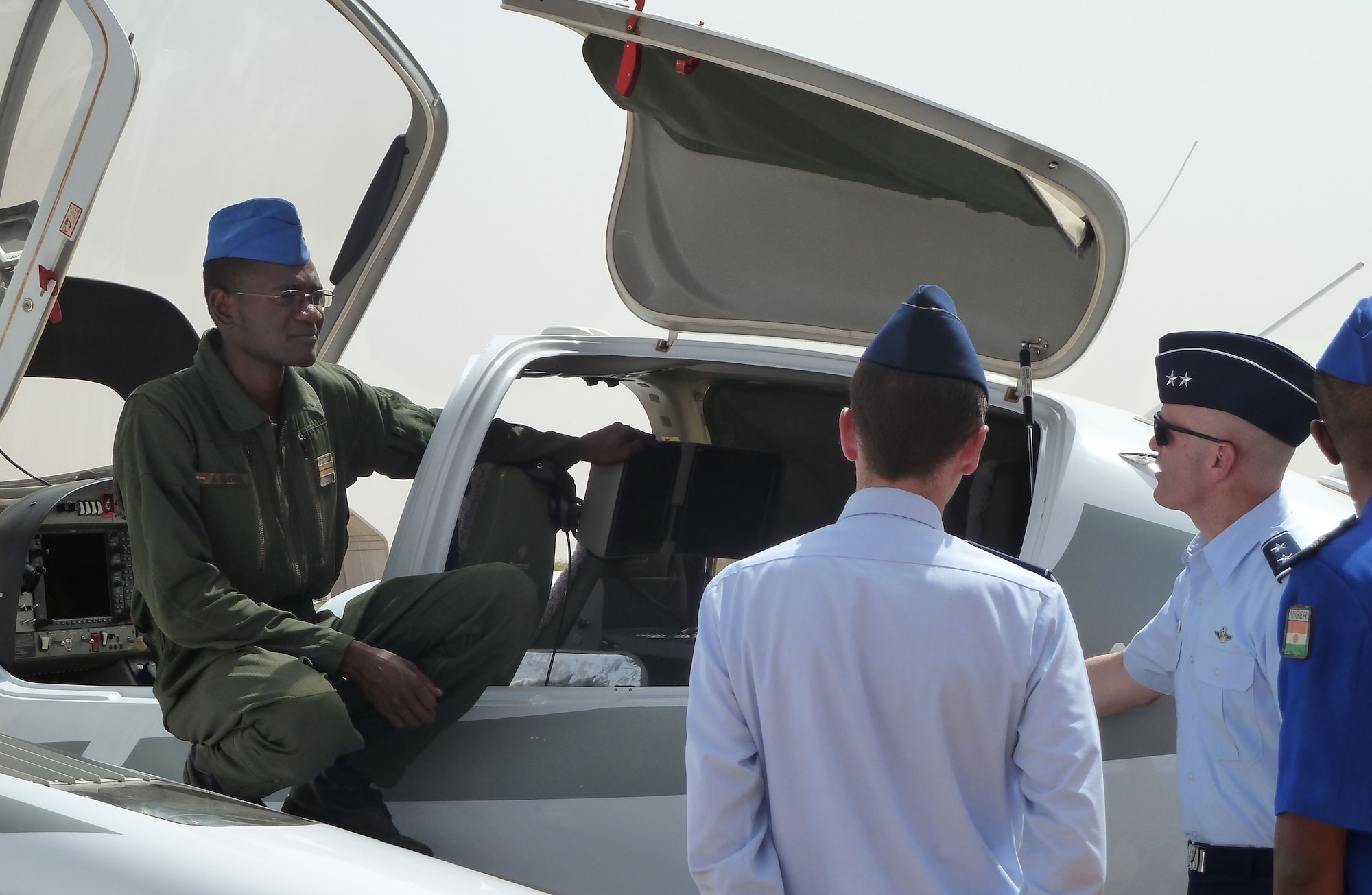 U.S. Maj. Gen. Carlton D. Everhart II, 3rd Air Force vice commander, discusses the capabilities of Nigerien air force assets with airmen at Base Aerienne 101, Niamey, Niger April 29, 2013. Everhart visited with Nigerien senior military leaders and airmen to exchange techniques and ideas on strengthening partnership capacities between the two air forces. (U.S. Air Force photo by Capt. Reba Good/Released)

