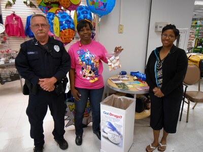 Officer Kevin Curry, a member from the 628th Security Forces Squadron, (middle) Carol Lampkin-Harris, a member of the 628th Medical Group Drug Demand Reduction Program, and (right) Master Sgt. Anitra Towns, 628th MDG noncommissioned officer in charge of pharmacy services, collect medication during the last Drug Enforcement Administration National Prescription Drug Take Back Day April 27, 2013, in the Navy Exchange at Joint Base Charleston – Weapons Station, S.C. The National Prescription Drug Take Back Day aims to provide a safe, convenient, and responsible means of disposal of prescription medicines, while also educating the general public about the potential for abuse of these medications. The JB Charleston – Air Base and Weapons Station collected more than 75 pounds of unwanted/expired prescription medications. (U.S. Air Force photo/Staff Sgt. Anthony Hyatt)