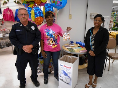 Officer Kevin Curry, a member from the 628th Security Forces Squadron, (middle) Carol Lampkin-Harris, a member of the 628th Medical Group Drug Demand Reduction Program, and (right) Master Sgt. Anitra Towns, 628th MDG noncommissioned officer in charge of pharmacy services, collect medication during the last Drug Enforcement Administration National Prescription Drug Take Back Day April 27, 2013, in the Navy Exchange at Joint Base Charleston – Weapons Station, S.C. The National Prescription Drug Take Back Day aims to provide a safe, convenient, and responsible means of disposal of prescription medicines, while also educating the general public about the potential for abuse of these medications. The JB Charleston – Air Base and Weapons Station collected more than 75 pounds of unwanted/expired prescription medications. (U.S. Air Force photo/Staff Sgt. Anthony Hyatt)