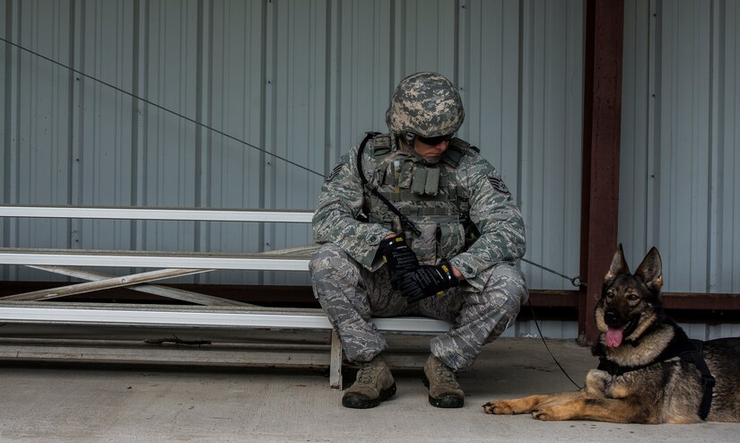 Staff Sgt. Kyle Shaughnessy, 628th Security Forces Squadron military working dog handler, and MWD Jaga, a 3-year old German Shepherd Dog, assigned to the 628th SFS at Joint Base Charleston, S.C., take a moment to prepare for an odor detection exercise, where Jaga detects odors associated with explosive or harmful materials used in homemade Improvised Explosive Devices.  Military Working Dogs  perform multiple duties and training including obedience skills, obstacle courses and various training objectives, depending on their specialized skill. (U.S. Air Force Photo / Airman 1st Class Tom Brading)