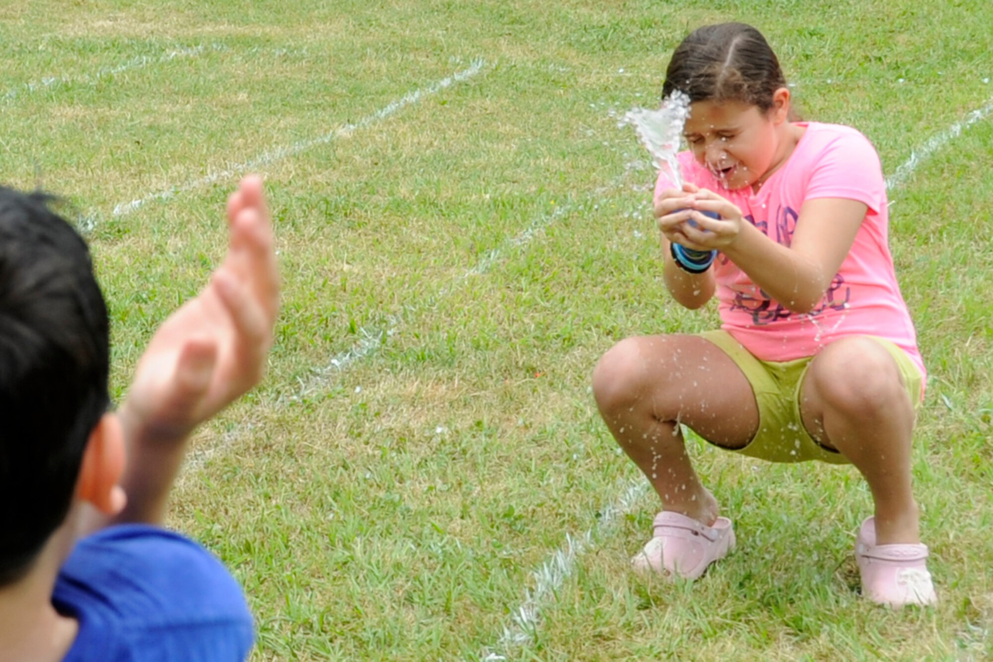 A young girl and her teammate fail to complete the water balloon toss at the 307th Bomb Wing/917th Fighter Group Family Day at Cullen Park on Barksdale Air Force Base, La., April 28, 2012. The annual event is an opportunity for the reserve members and their families to get together for some fun and camaraderie. There was also a car show for the automotive enthusiasts at the celebration. (U.S. Air Force photo by Master Sgt. Jeff Walston/Released)