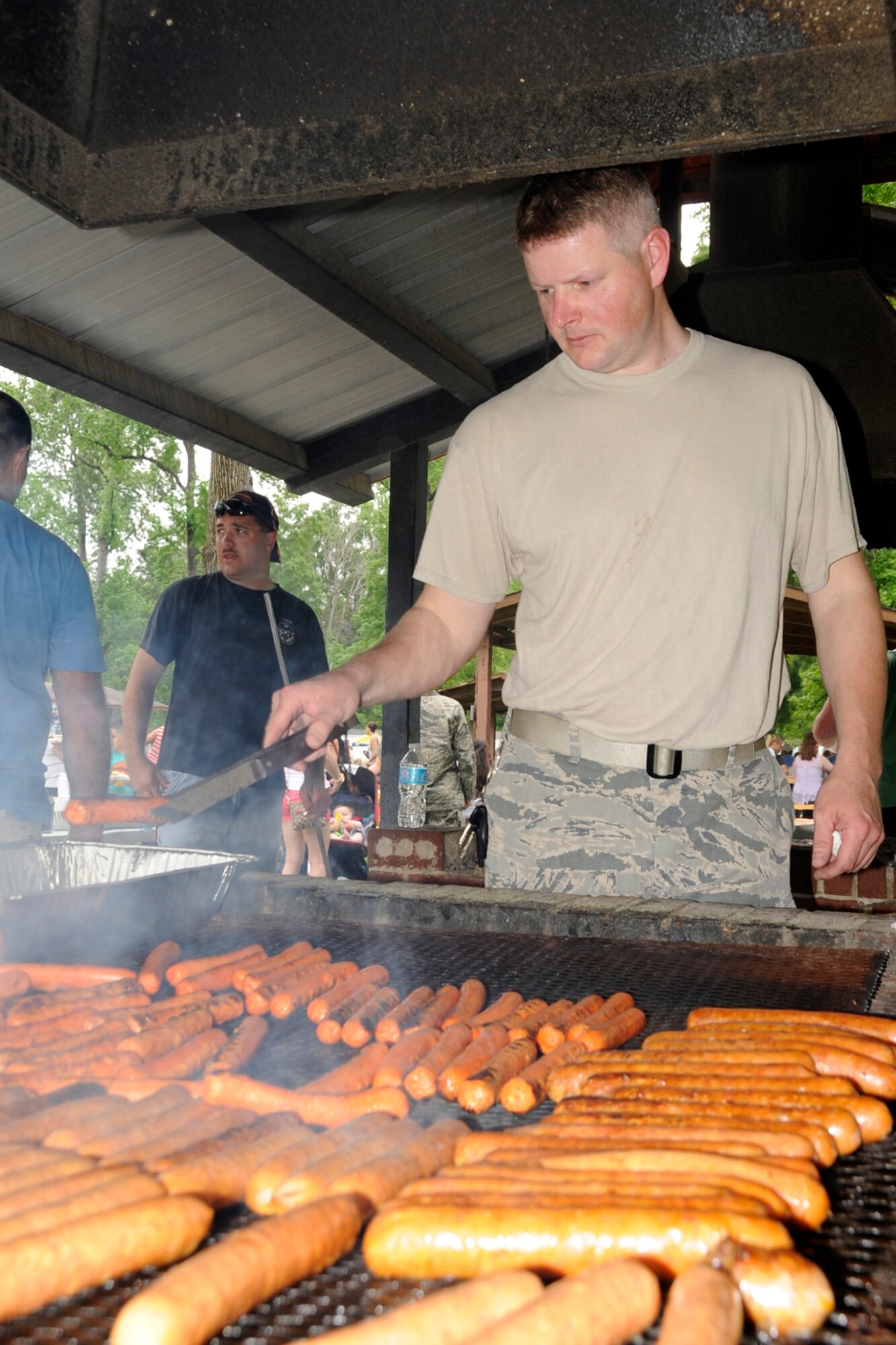 U.S. Air Force Tech. Sgt. David Priester, power production, 307th Civil Engineer Squadron, volunteers as a cook for the day at the 307th Bomb Wing/917th Fighter Group Family Day at Cullen Park on Barksdale Air Force Base, La., April 28, 2012. The annual event is an opportunity for the reserve members and their families to get together for some fun and camaraderie. (U.S. Air Force photo by Master Sgt. Jeff Walston/Released)