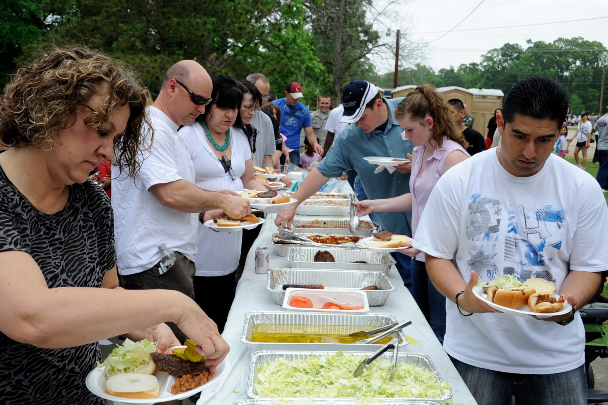 Some attendees at the 307th Bomb Wing/917th Fighter Group (917 FG) Family Day get busy eating at Cullen Park on Barksdale Air Force Base, La., June 2, 2012. The annual event is an opportunity for the reserve members and their families to get together for some fun and camaraderie. This year’s combined unit event is bitter sweet since the 917 FG will be inactivated in September 2013. (U.S. Air Force photo by Master Sgt. Jeff Walston/Released)