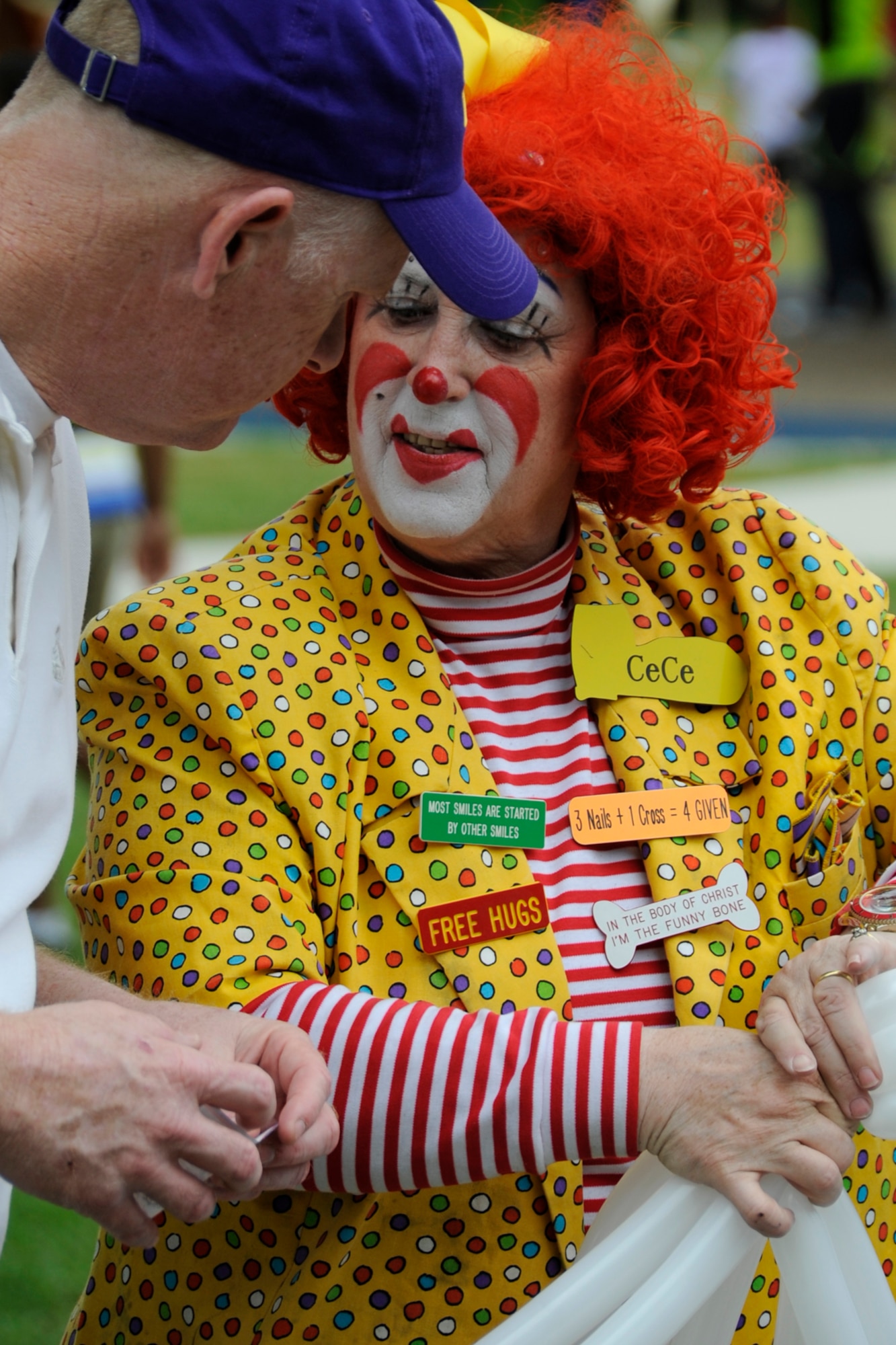 U.S. Air Force Chief Master Sgt. Douglas McClain, superintendent, 307th Force Support Squadron,  speaks with CiCi the Clown while she sculpts balloons at the 307th Bomb Wing/917th Fighter Group Family Day at Cullen Park on Barksdale Air Force Base, La., April 28, 2012. The annual event is an opportunity for the reserve members and their families to get together for some fun and camaraderie. (U.S. Air Force photo by Master Sgt. Jeff Walston/Released)