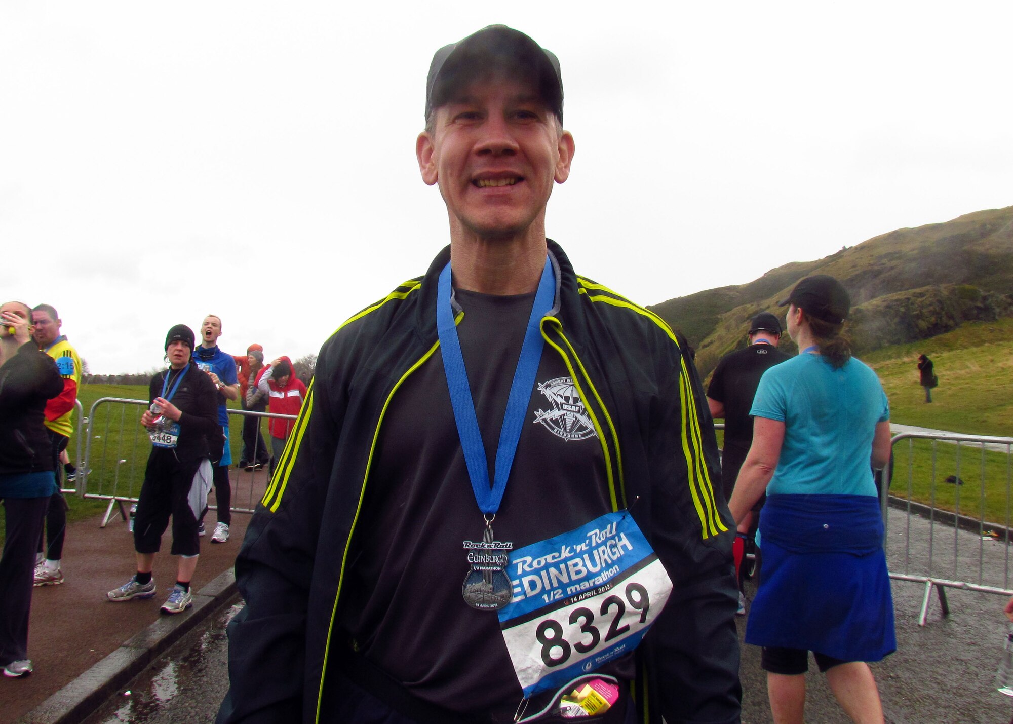 Master Sgt. Brion Rockel, 100th Operations Support Squadron Weather flight chief, wears his medal after running the 2013 Rock-n-Roll Half-Marathon in Edinburgh, Scotland. Several Airmen competed in the 13.1-mile event battling heavy winds, near-freezing temperatures and pelting rain. Rockel finished the race in 2 hours, 10 minutes. (Courtesy photo/Released)