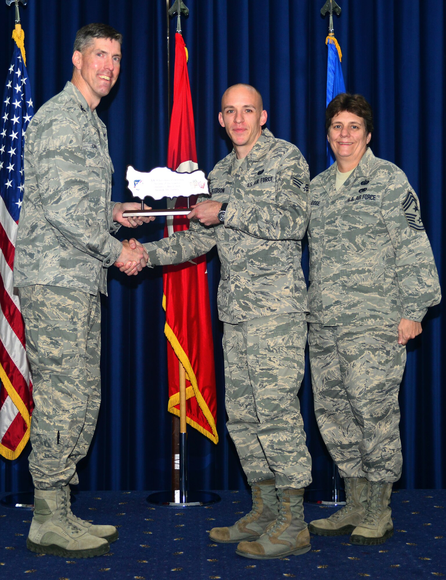 Senior Airman Christian Peterson, 39th Communications Squadron, receives Incirlik Airman of the Quarter award from Col. Chris Craige, 39th Air Base Wing commander and Chief Master Sgt. Nancy Judge, 39th ABW command chief, during a combined quarterly awards and promotion ceremony April 30, 2013, at Incirlik Air Base, Turkey. (U.S. Air Force photo by Staff Sgt. Eric Summers Jr./Released)