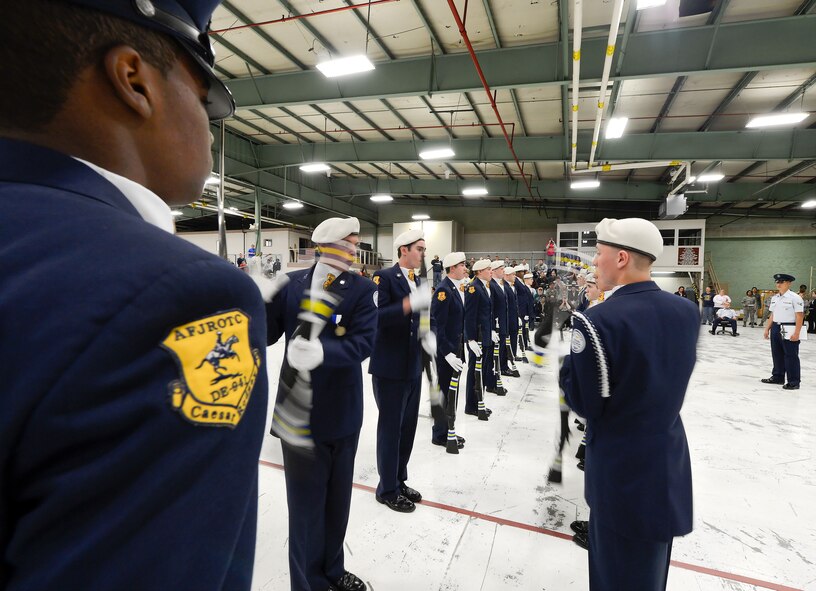 Members of Air Force Junior Reserve Officer Training Corps unit 941, Caesar Rodney High School, Camden, Del., spin their M-1 carbine rifles as the units' deputy commander, Cadet Lt. Col. Bryce Jackson, left, begins to walk through the row they have formed during the armed drill exhibition competition. The 436th Logistics Readiness Squadron, 436th Airlift Wing, hosted the 2013 JROTC competition at Dover AFB. (U.S. Air Force photo/Greg L. Davis)