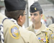 A senior ranking Navy Junior Reserve Officer Training Corps (JROTC) cadet inspects the uniform of another cadet during the 2013 JROTC drill competition, April 20, 2013, hosted by the 436th Logistics Readiness Squadron, 436th Airlift Wing, Dover Air Force Base, Del. (U.S. Air Force photo/Greg L. Davis)